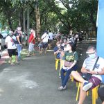 A long line of people forms near the vaccination site in Barangay Kaligayahan, Novaliches-Fairview in Quezon City on Friday (July 2, 2021). Those scheduled to be vaccinated are the individual workers for their first dose and the elderly for their second dose. (PNA photo by Oliver Marquez)