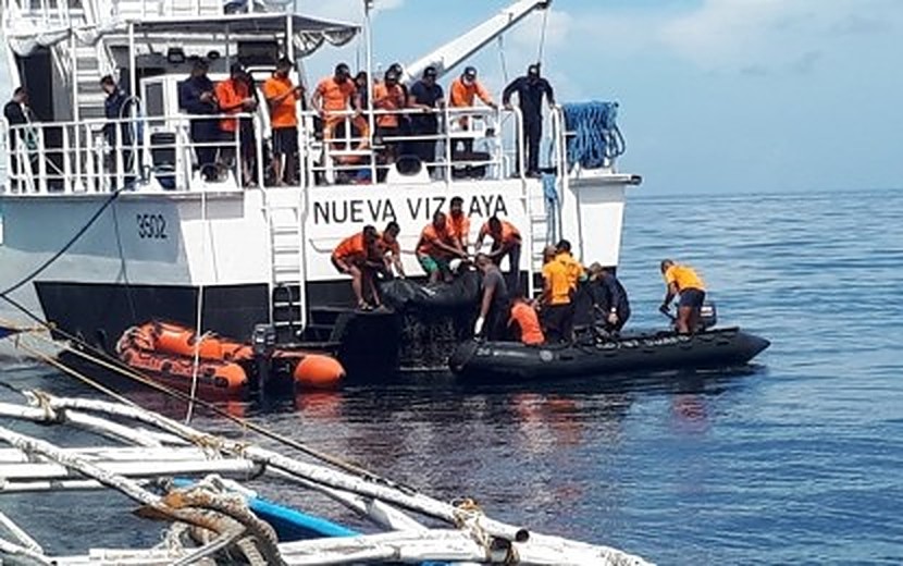 Philippine Coast Guard Search And Rescue Personnel Bring A Body Aboard ...