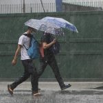 Two persons walking under the rain. (Photo from PNA)