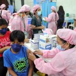 A health worker administers an anti-COVID-19 vaccine to a teenager at the De La Salle University campus in Dasmariñas City, Cavite on Friday (Nov. 19, 2021). The government targets to vaccinate 12.7 million minors aged 12 years to 17 years. (PNA photo by Gil Calinga)