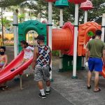 Guardians watch over their children playing at a public park in Barangay 187, Tala, Caloocan City on Friday (Nov. 19, 2021). As the National Capital Region is under Alert Level 2, children are allowed out so long as they practice safety protocols against Covid-19 and are supervised by adults. (PNA photo by Ben Briones)