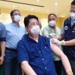 Health Sec. Francisco Duque administers a booster dose to a civilian during the ceremonial vaccination held at  East Avenue Medical Center in Quezon City on Nov. 22.