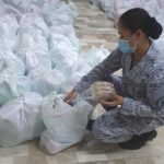 A member of the NFEM packing relief goods for typhoon victims. (Photo from NFEM Facebook page)