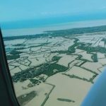 A photo taken inside a plane showing flooded areas in Negros Occidental brought by the onslaught of Typhoon Odette. (Photo from PNA)
