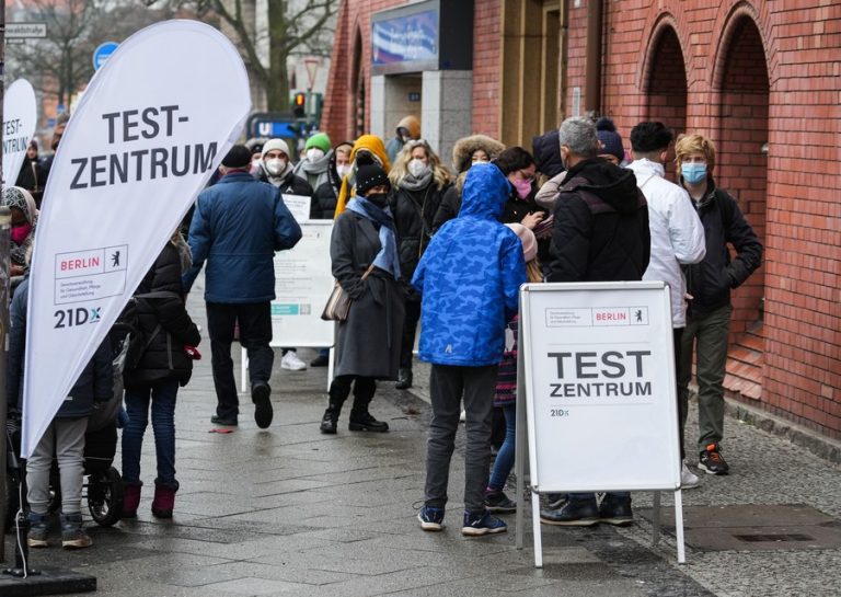 People line up to receive COVID-19 tests at a test station in Berlin, Germany, on Jan. 12, 2022. (Photo by Stefan Zeitz | Xinhua)
