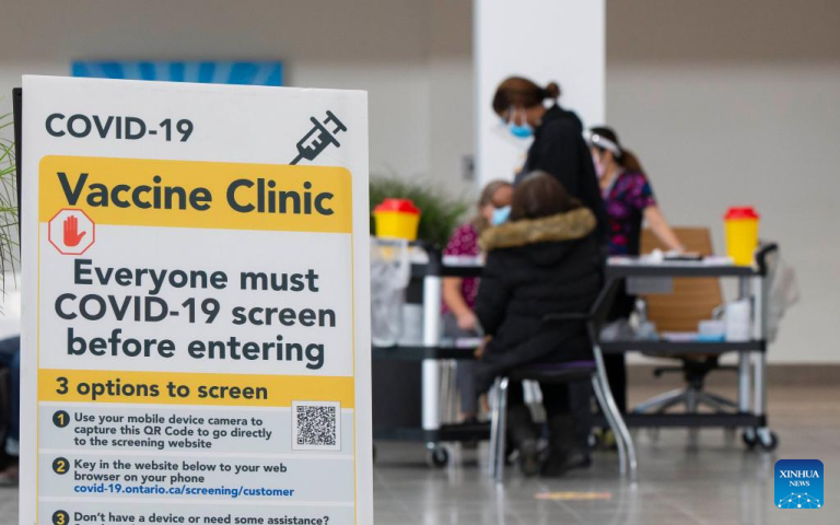 A notice of COVID-19 screening is seen at a COVID-19 vaccine clinic in Mississauga, Ontario, Canada, on Jan. 14, 2022. Canada reported 20,036 new COVID-19 cases Friday (Jan. 14) noon, raising its national total to 2,706,977 cases with 31,306 deaths, according to local media CTV. (Photo by Zou Zheng | Xinhua)