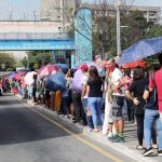 Passengers queue up to get a ride along Commonwealth Avenue in Philcoa, Quezon City on Monday (Feb. 21, 2022). Some transport groups have called for a provisional increase in fares to help cushion the impact of soaring oil prices on their livelihood. (PNA photo by Joey O. Razon)