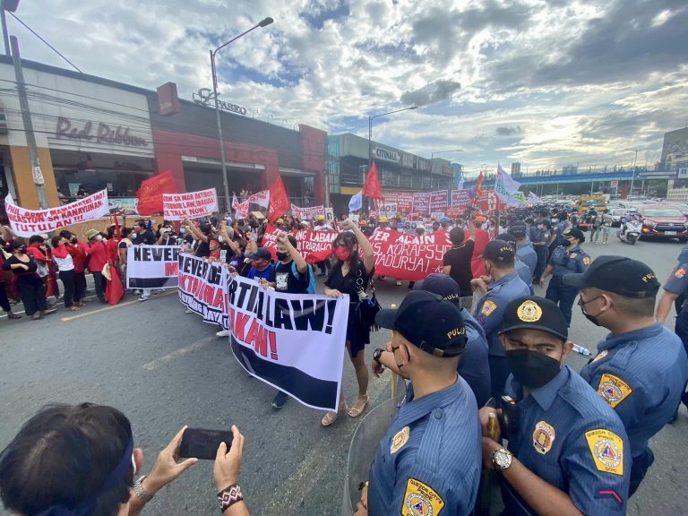 Protesters march to commemorate 50th anniversary of martial law