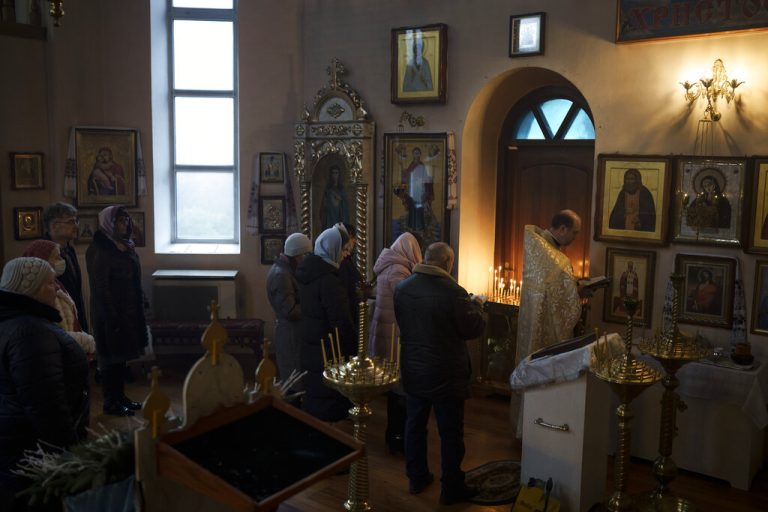 Ukrainians attend a Christmas mass at an Orthodox Church in Bobrytsia, outskirts of Kyiv, Ukraine, Sunday, Dec. 25, 2022. Sunday began with the sound of sirens, but that didn't prevent people from gathering in the church and attend for the first time a Christmas mass on Dec. 25. (AP Photo/Felipe Dana)